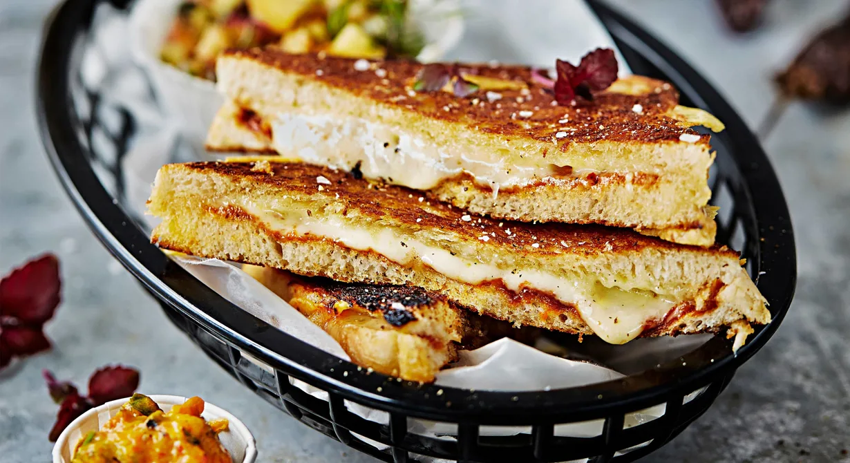 Grilled cheese är en amerikansk klassiker och för alla som älskar ost är det här den ultimata mackan. Fyll skivat bröd med mycket ost och lite chipotle paste eller annan pikant smaksättare för spännande smak. Servera med goda tillbehör som frisk persikosalsa och paprikaröra mojo rojo.